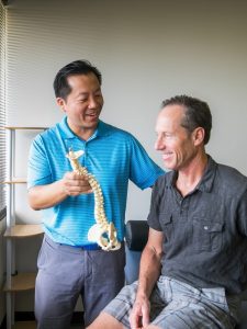 Doctor Lin teaching spinal issues to patient