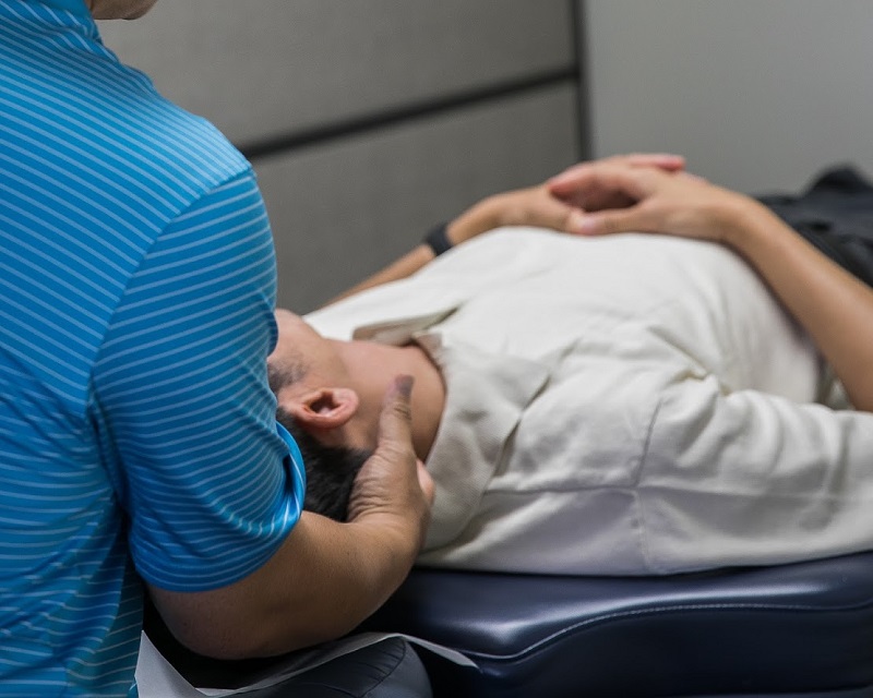 Chiropractor adjusting Patient's Neck